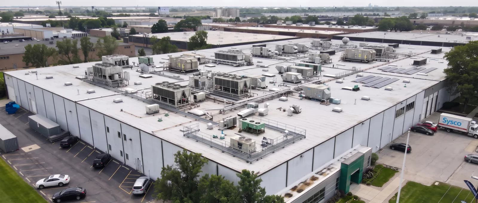 Aerial view of a commercial building roof crowded with rooftop mechanical units